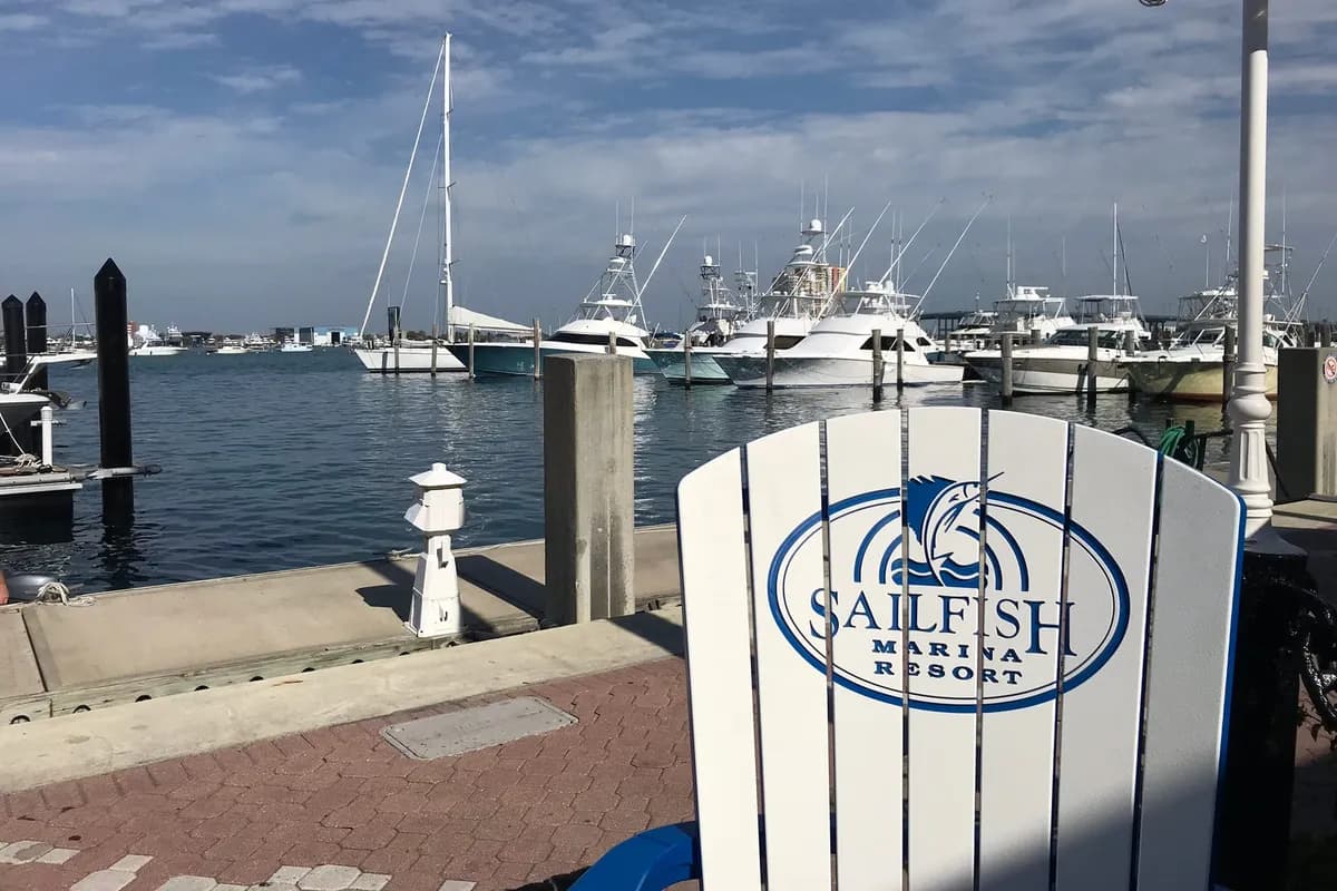 A Sailfish Marina Resort chair on the dock in Palm Beach Shores, with sportfishing boats in the marina behind