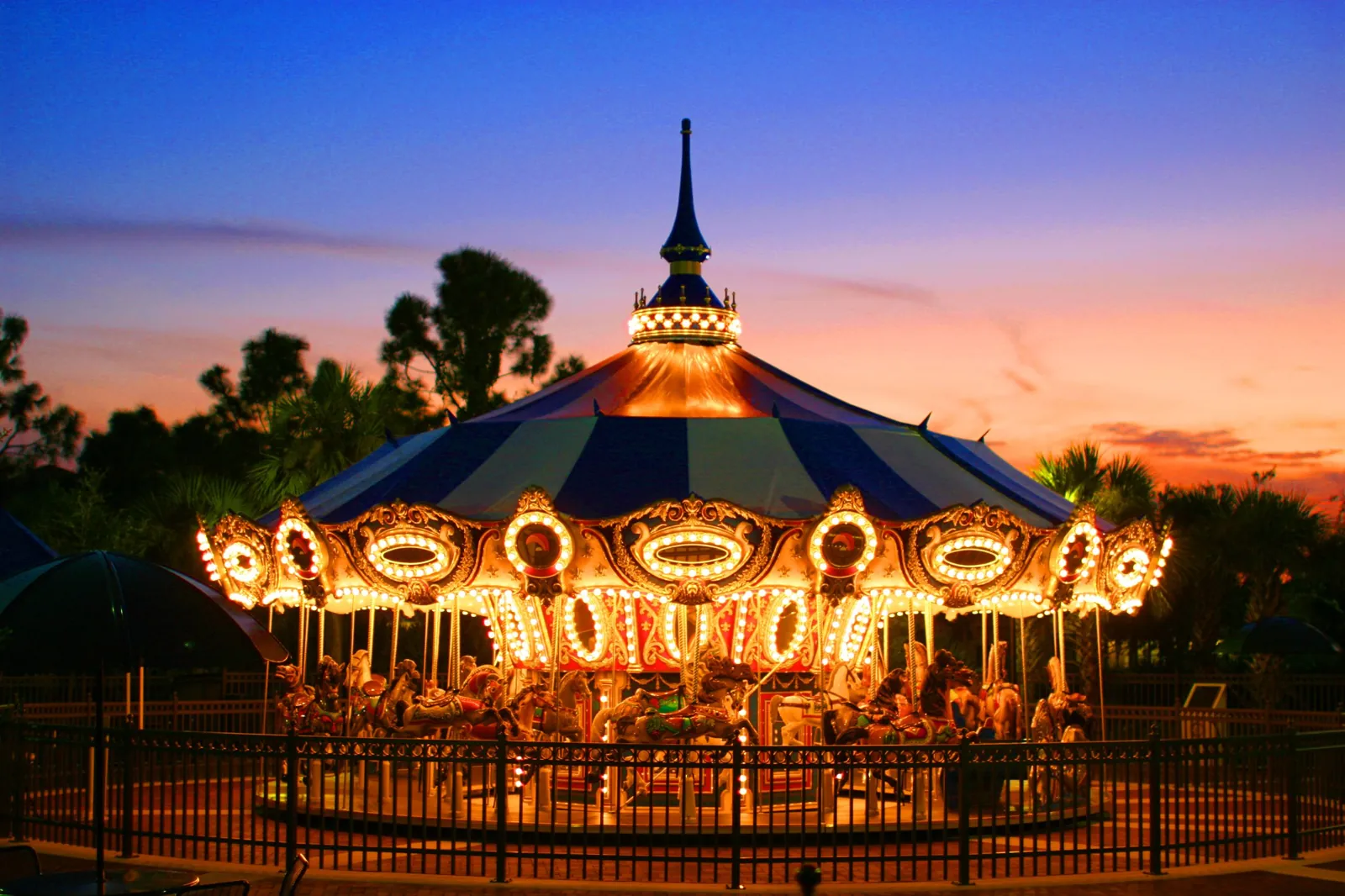 Illuminated vintage-style carousel at twilight