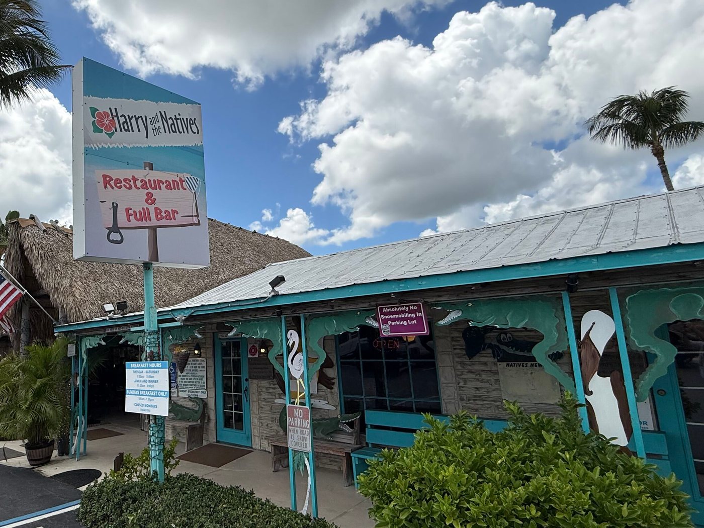 The teal porch and hand-painted roadside sign of Harry and the Natives on US-1 in Hobe Sound, Florida