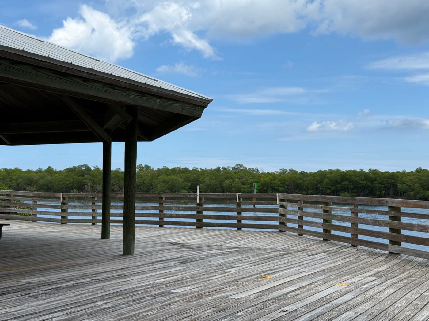 A covered pavilion on a wooden deck over the Indian River Lagoon at Peck Lake Park