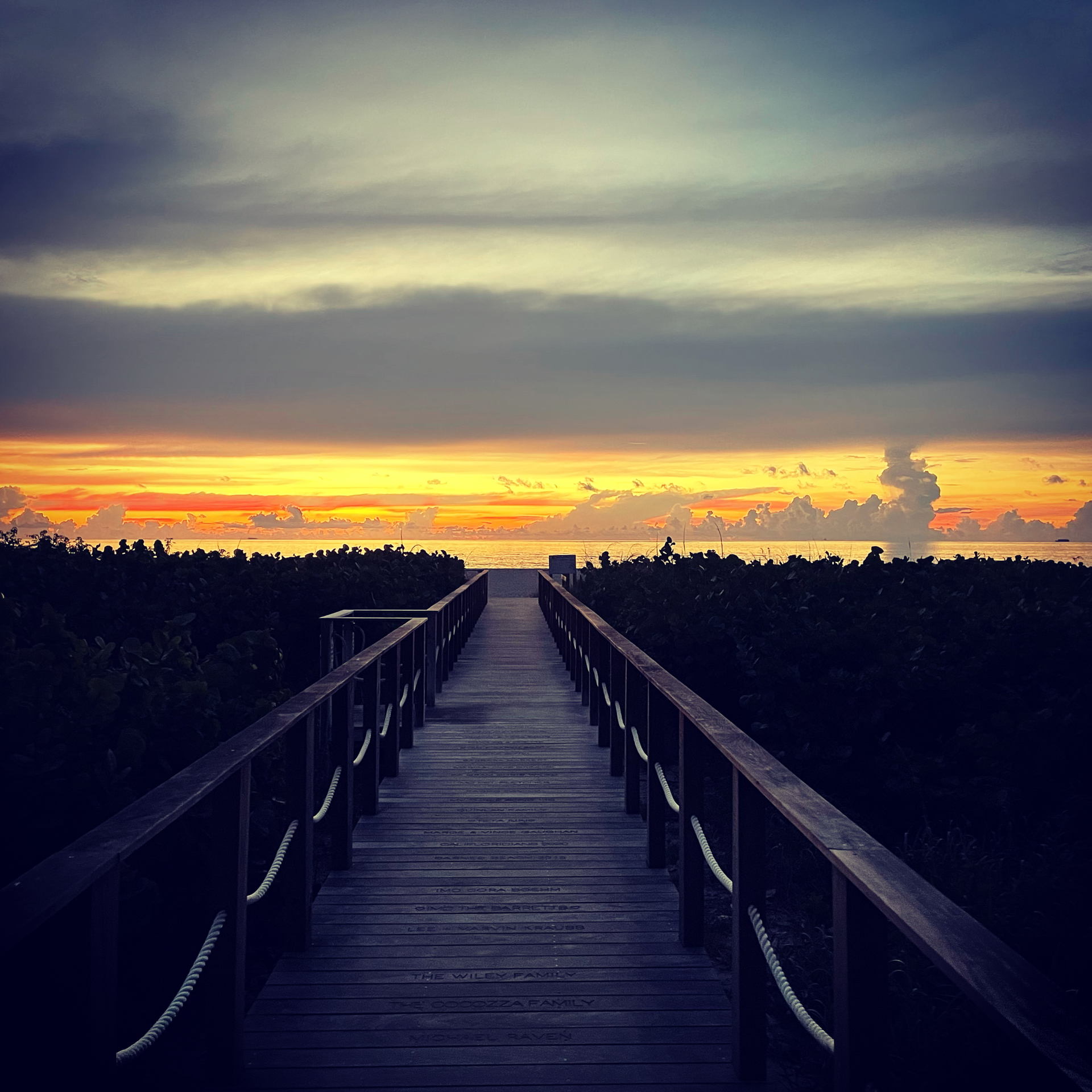 Beach access boardwalk at sunrise in Juno Beach, Florida