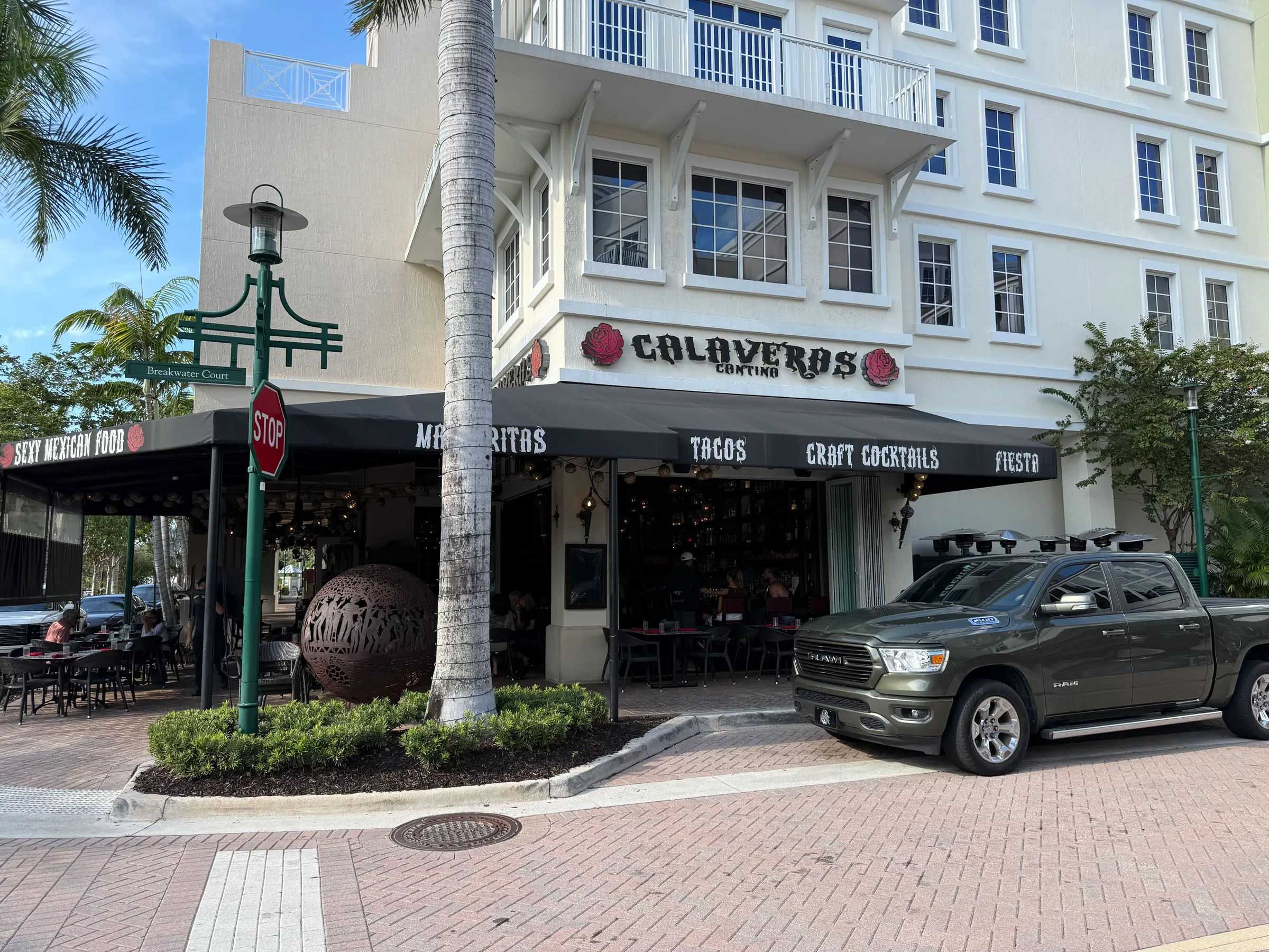 Calaveras Cantina at Harbourside Place, a corner restaurant with a black awning advertising margaritas, tacos and craft cocktails