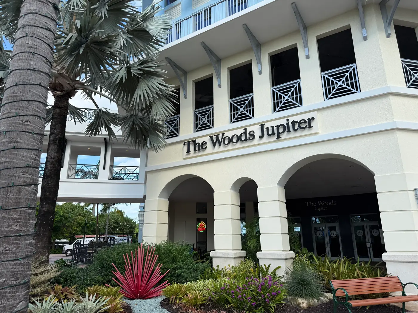 The Woods Jupiter restaurant front at Harbourside Place, with its sign over the entrance