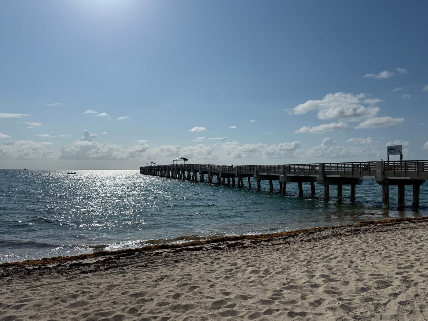 The William O. Lockhart Municipal Pier running out into the Atlantic, photographed from the sand in morning light