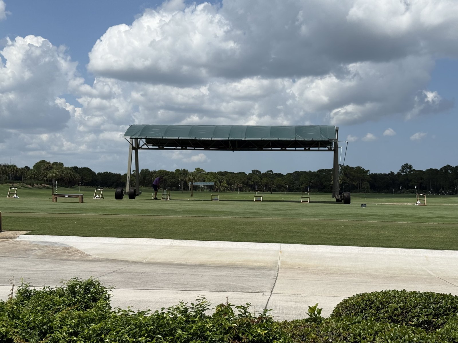 Covered hitting bays across the practice range at PGA Golf Club