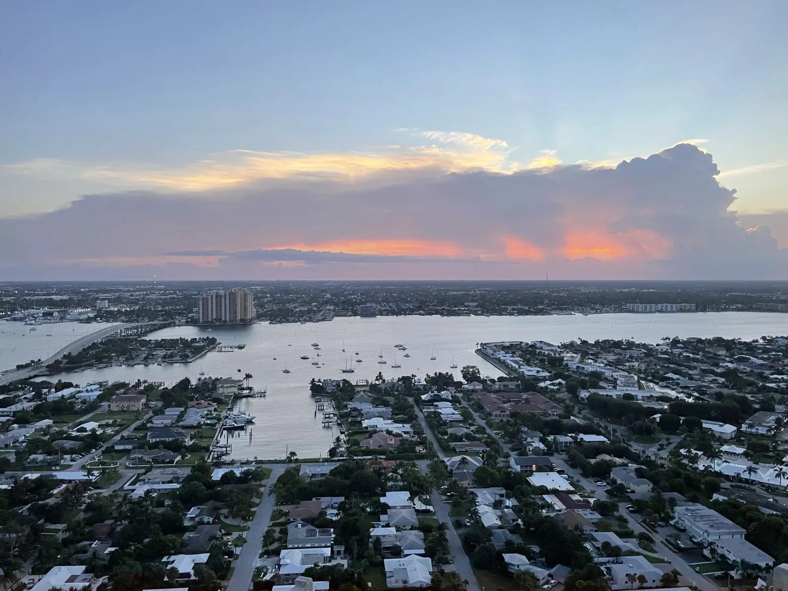 High-rise aerial view of waterfront residential neighborhood and intracoastal at sunset