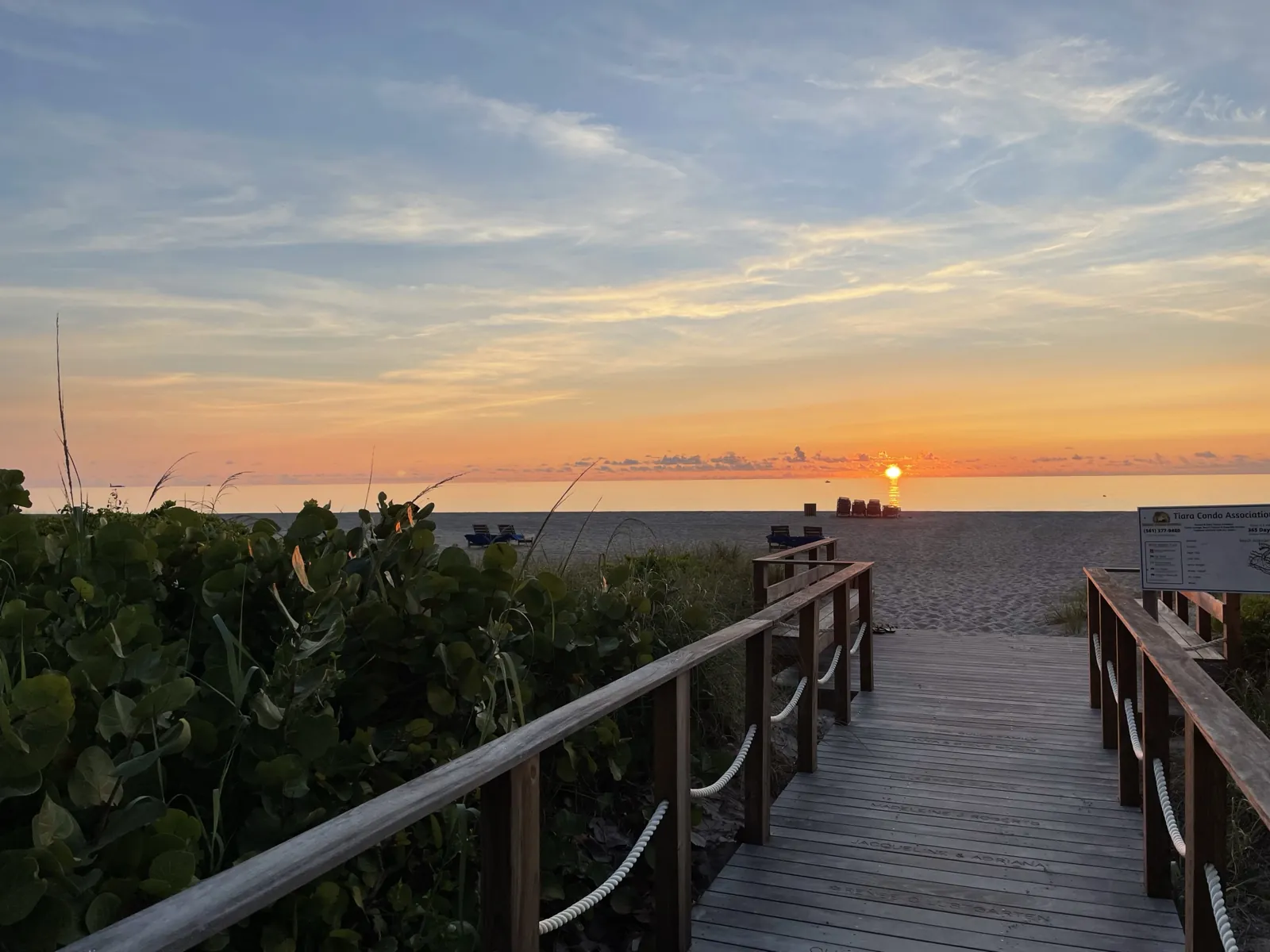 Sunrise over the Atlantic from a wooden beach boardwalk with rope railings