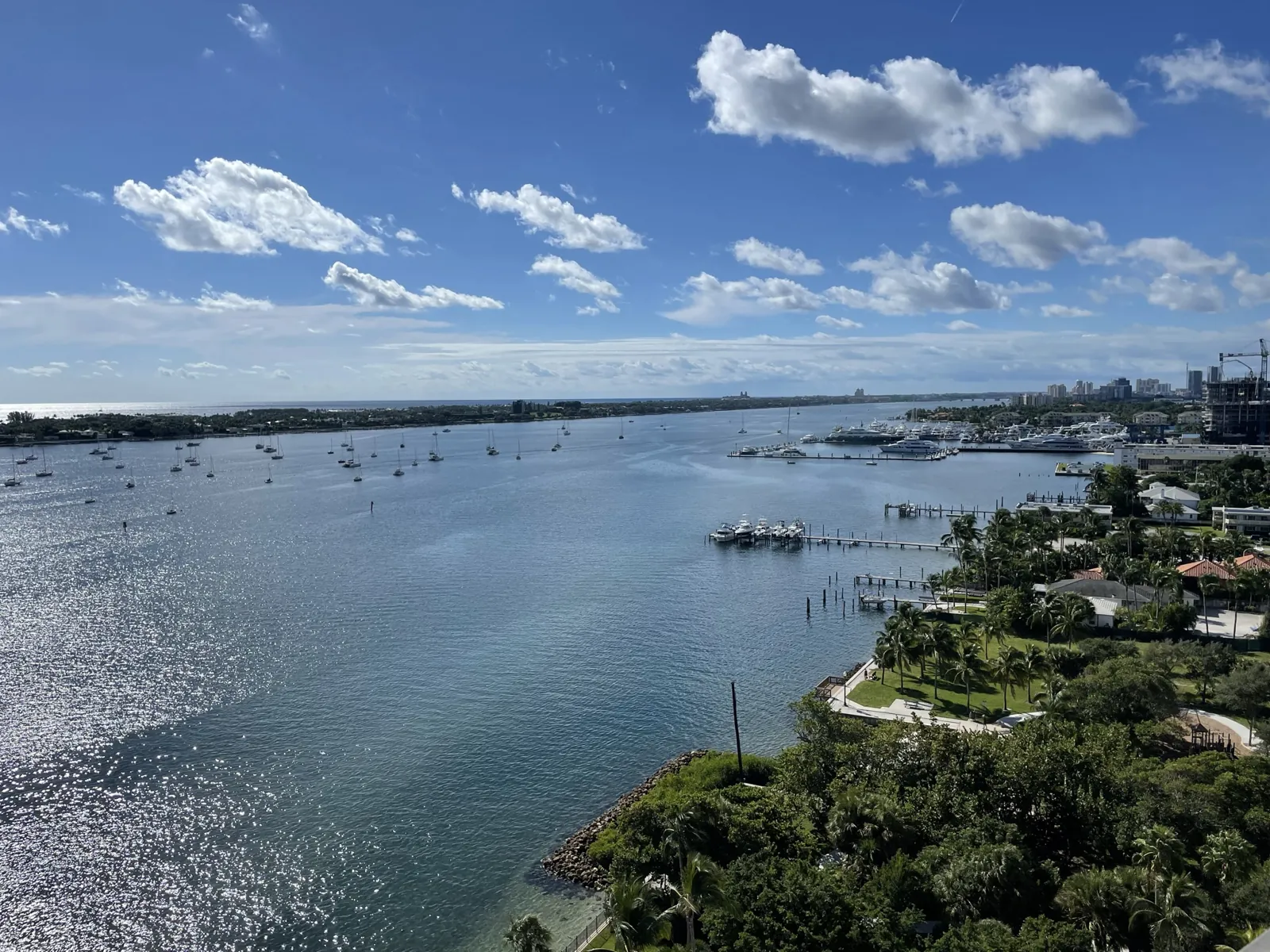 Elevated view over Intracoastal Waterway with anchored sailboats, marina docks and tropical waterfront