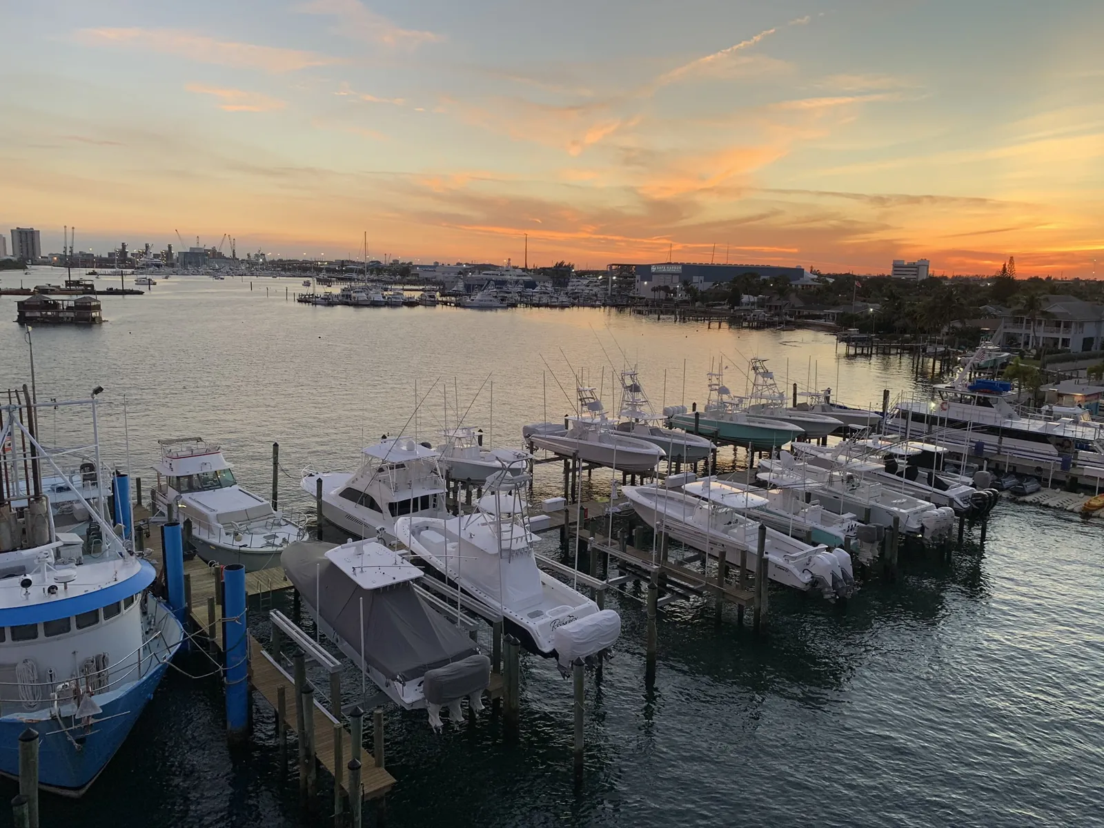 Marina at sunset with docked sport-fishing boats on lifts