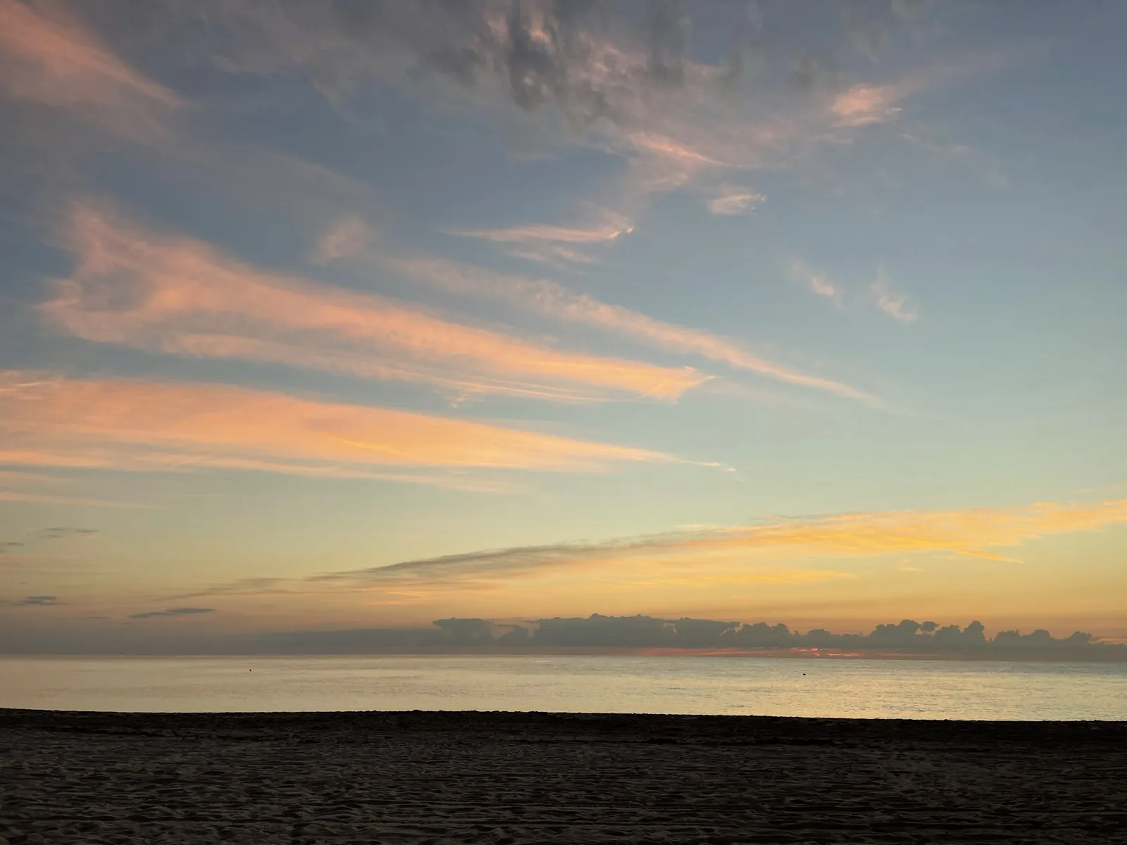 Sunrise sky over calm Atlantic Ocean from the beach