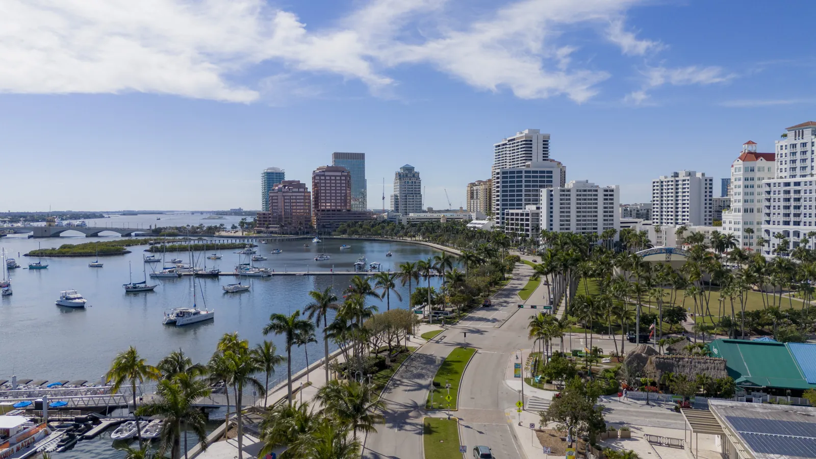 Aerial view of a waterfront boulevard, marina and downtown high-rise skyline