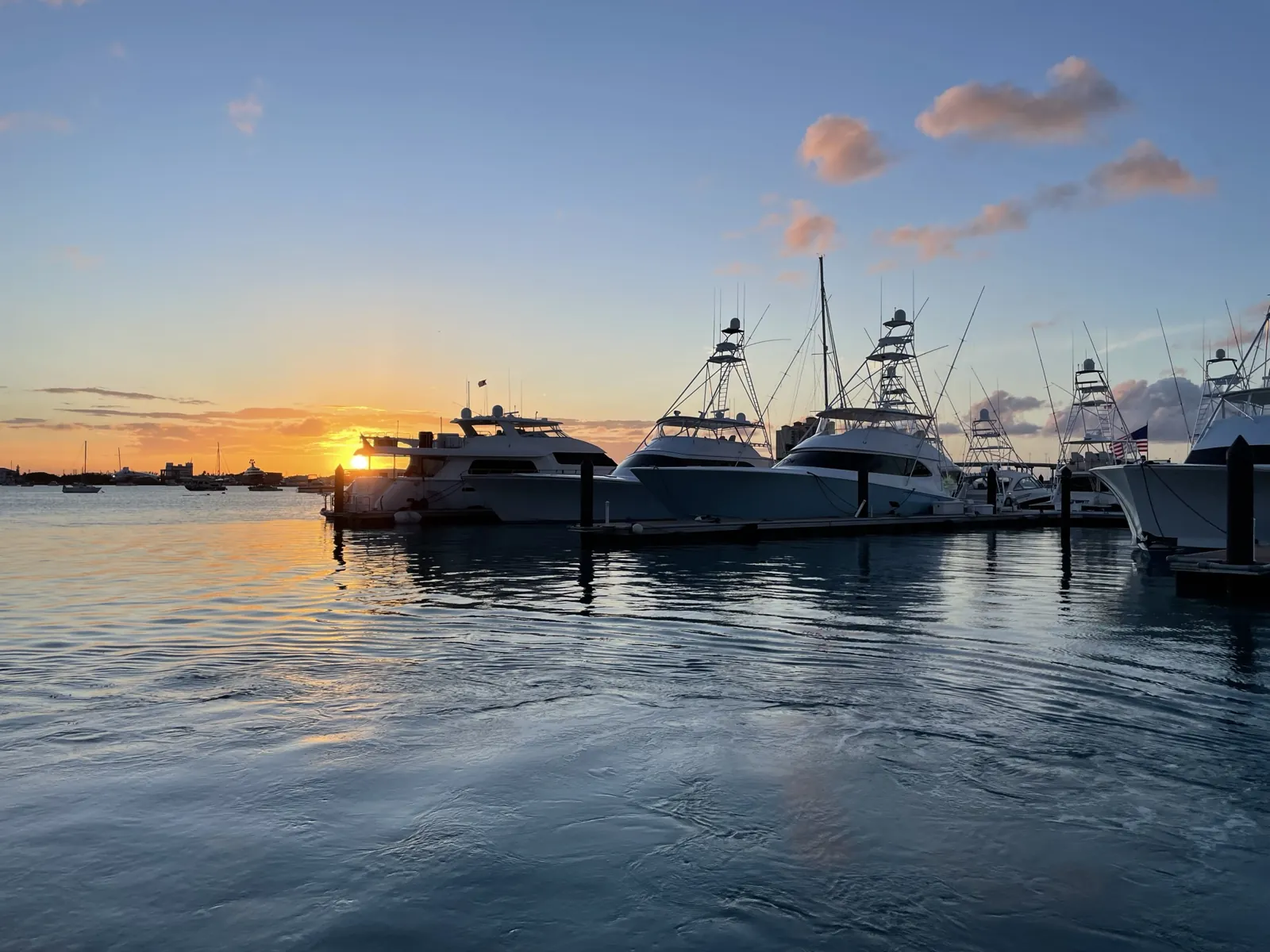 Sunset over marina with moored sportfishing yachts
