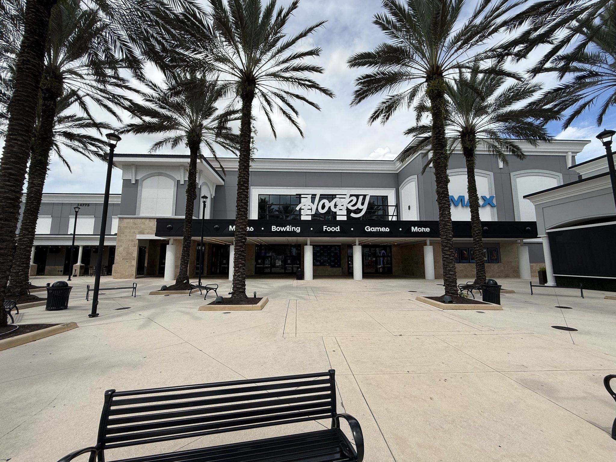 The Hooky entertainment building at Delray Marketplace, with a banner reading Movies, Bowling, Food, Games, More and an IMAX sign